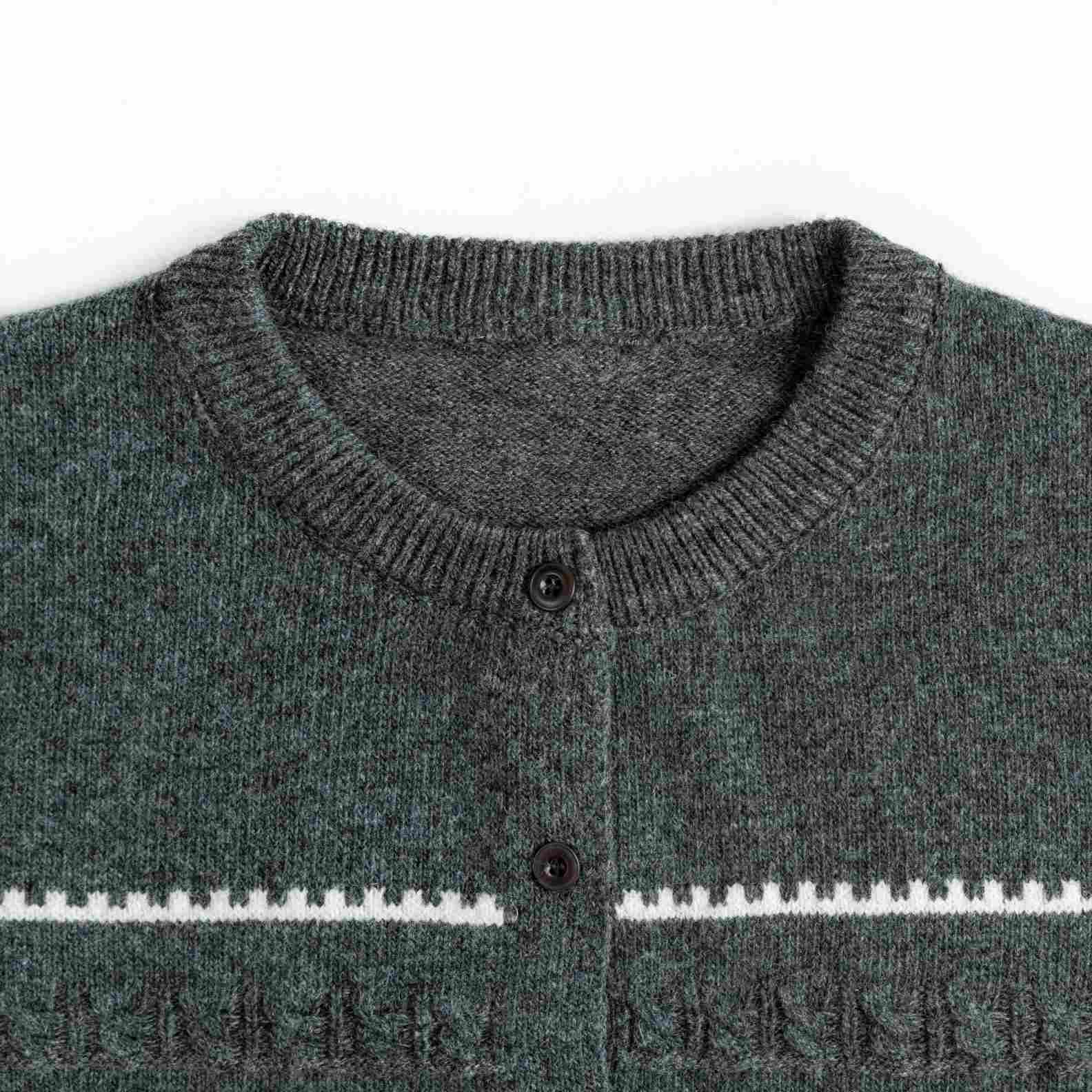 A cozy wool knit cardigan in heather grey. Featuring a classic round neck, a button-front closure, and white geometric intarsia bands across the chest and sleeves. (1)