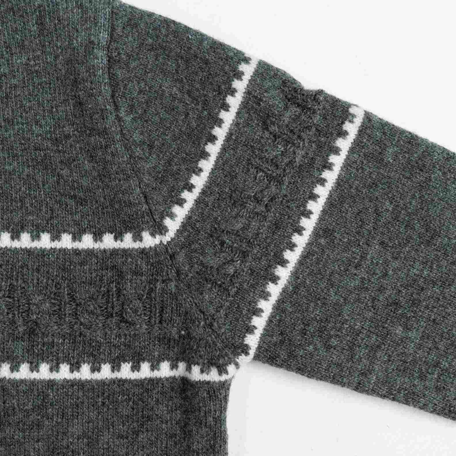 A cozy wool knit cardigan in heather grey. Featuring a classic round neck, a button-front closure, and white geometric intarsia bands across the chest and sleeves. (3)